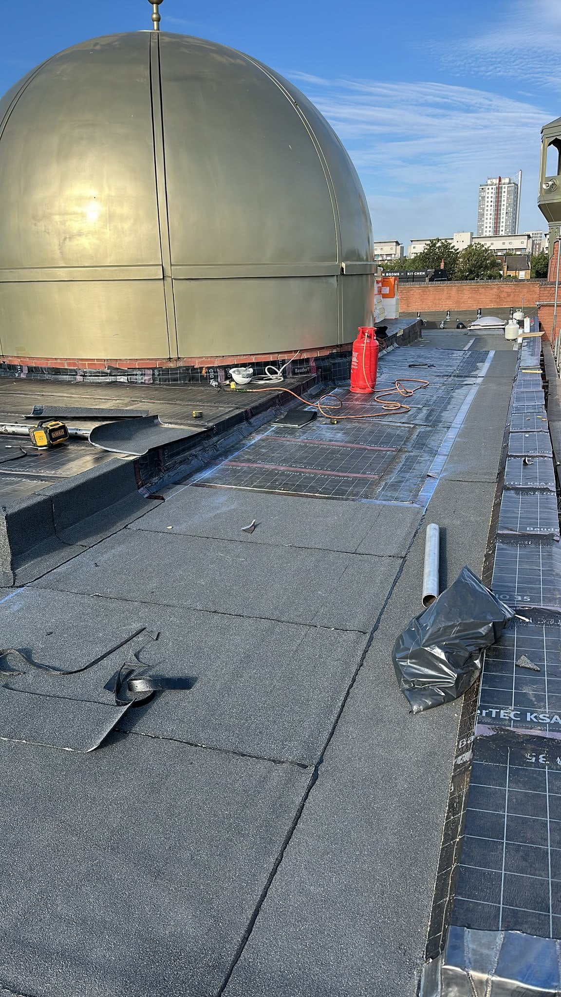 Tapered insulation and mineral cap sheet works beside the dome